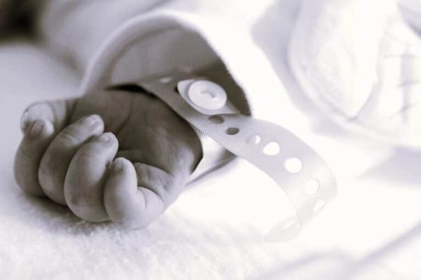 AdobeStock_349728082-infant-hand-nicu-resized-b-w-768x545